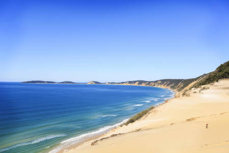 a sandy beach next to a body of water