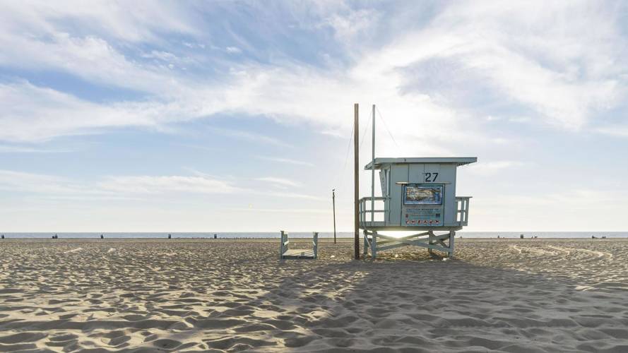 a sandy beach next to the ocean