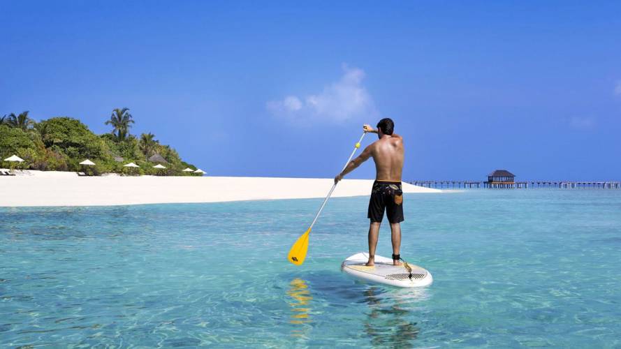 a man standing next to a body of water