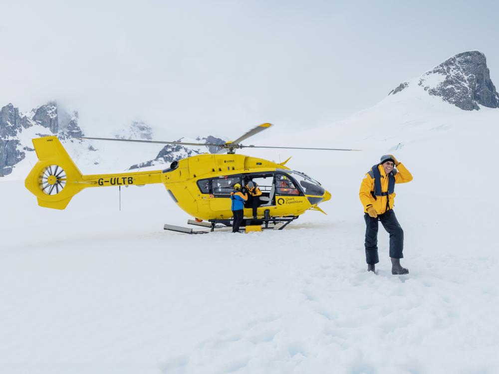 A helicopter landed on the Antarctic snow
