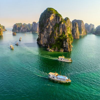 Aerial view floating fishing village and rock island, Halong Bay, Vietnam, Southeast Asia. UNESCO World Heritage Site. Junk boat cruise to Ha Long Bay. Popular landmark, famous destination of Vietnam