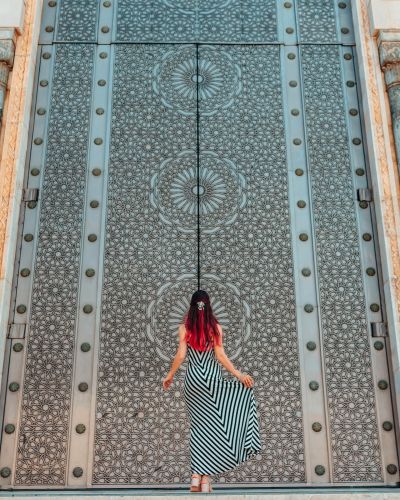Morocco travel guide - Girls standing in front of greatest mosque Hasan II in Morocco, Africa - Top six destinations we can't wait to visit again