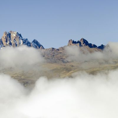 Aerial of Mount Kenya, Africa with snow and white puffy clouds in January
