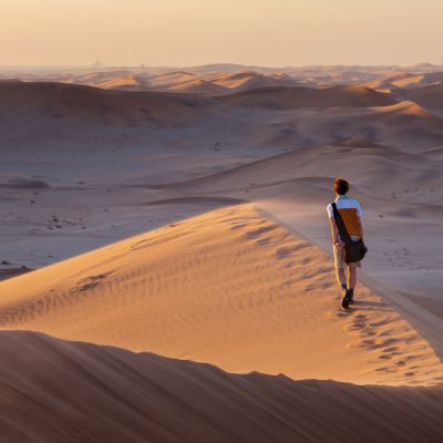 Tourist walking on the scenic dunes of Sossusvlei, Namib desert, Namib Naukluft National Park, Namibia, Africa