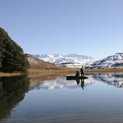 flyfishing for trout against a backdrop of snow at giants cup wilderness reserve, kwazulu natal, south africa - history of South Africa