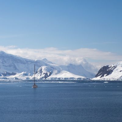 A sailing ship sails through the neumayer channel, Antarctica
