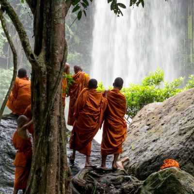 Group of young buddhist monks enjoying the view of Kulen Waterfall in Cambodia, Asia