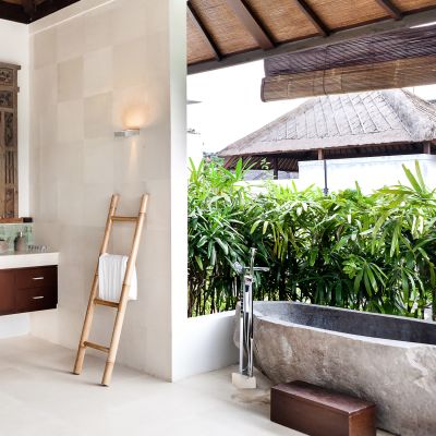 Bathing area from the outside with the wash area that covered with plants, stone or cement basin, tub to shower, Indonesia, Asia