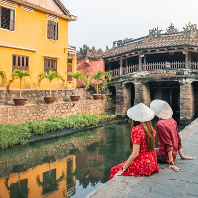 Travel couple with Japanese Covered Bridge, in Hoi An, Vietnam, Asia