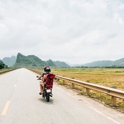 Young traveler couple making a adventure journey trip with a vintage motorcycle in Vietnam, Asia