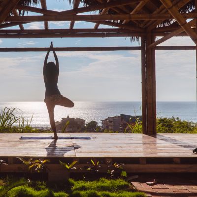 Woman practising yoga in bamboo studio, Ecolodge retreat in Montanita, Ecuador, South America