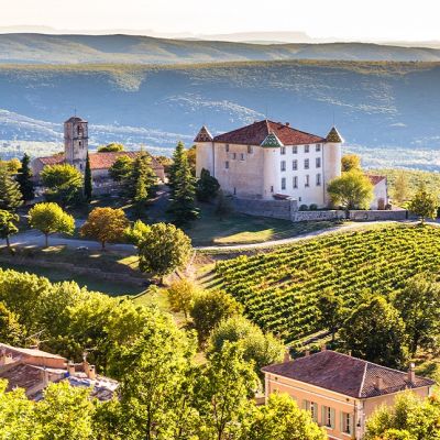 View Of Aiguines Village And Renaissance-style Chateau Overlooking Lac de Sainte Croix Lake-Alpes de Haute Provence, France