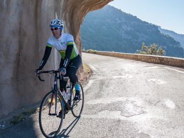 Cycling through a tunnel in the Nesque Gorge, France