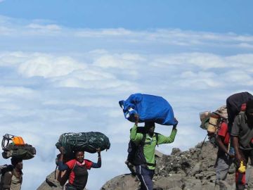 Female porters climbing Kilimnjaro