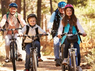 Family cycling through woodland