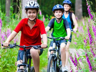 Family cycling through woodland