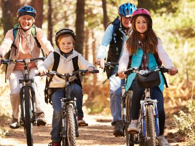 Family cycling through woodland