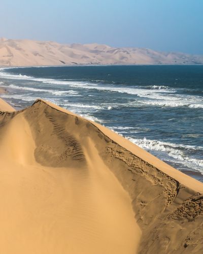 Atlantic coast of Walvis Bay, Namibia. Ocean surf with foamy waves
