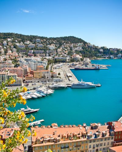 Enchanting Travels France Tours Panoramic view of Nice harbour with blue sky, France