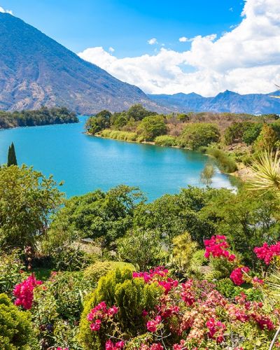 Enchanting Travels Guatemala Tours Lake Atitlan Beautiful bay of Lake Atitlan with view to Volcano San Pedro in highlands of Guatemala, Central America