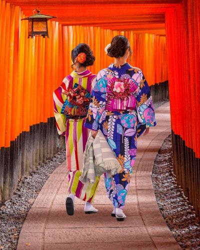 Top 10 temples in Japan - Women in traditional japanese kimonos walking at Fushimi Inari Shrine in Kyoto, Japan