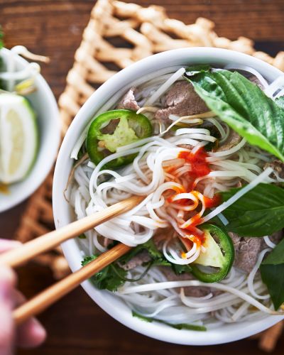 vietnamese pho with spicy sriracha sauce shot top down