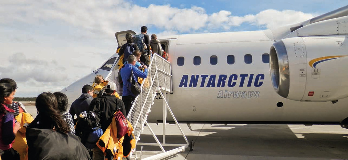 Guests going up stairs as their board our chartered flight from Punta Arenas, Chile.
