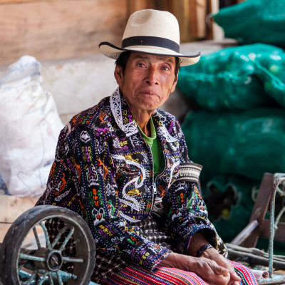 Senior man from Guatemala in ethnic traditional Latin American clothing at a market
