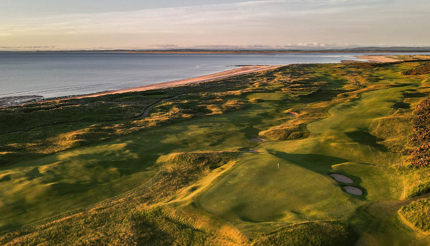 An aerial view of the 4th and 12th holes at Royal Dornoch Golf Club along the coast of the North Sea in Dornoch, Scotland.