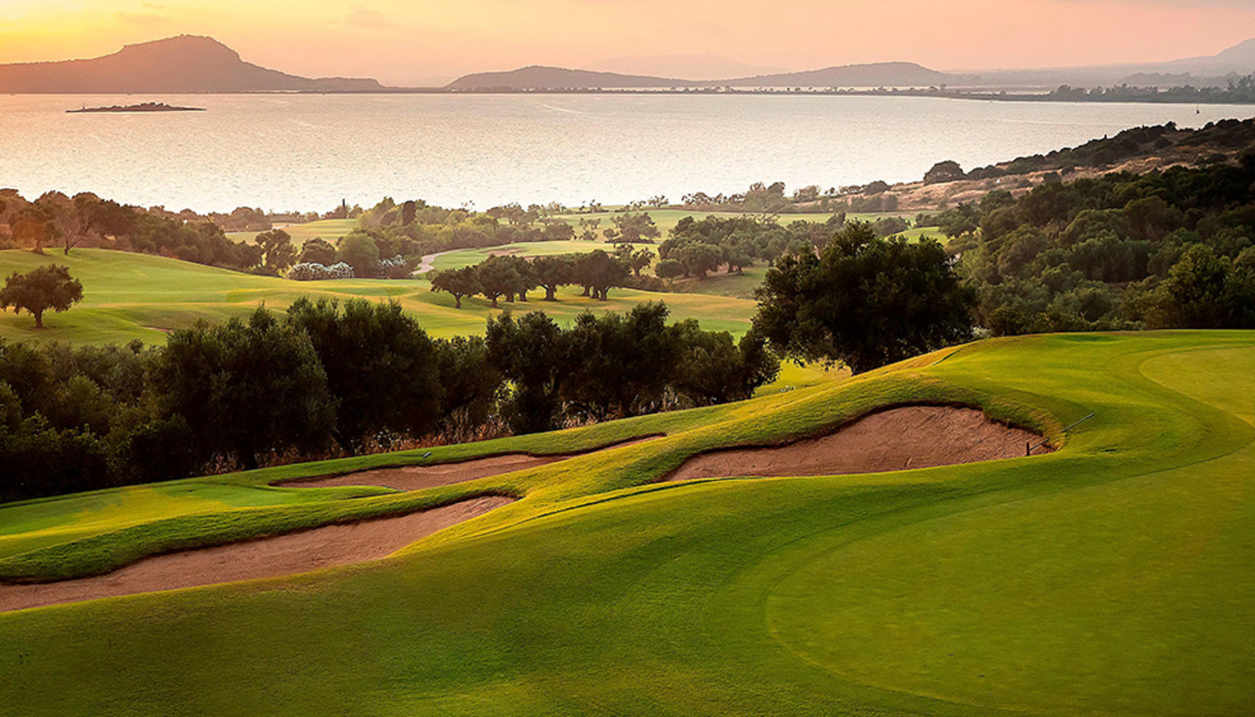 Bunkers guard the 17th green surrounded by trees on the Dunes Course at Costa Navarino Golf Resort in Costa Navarino, Greece.