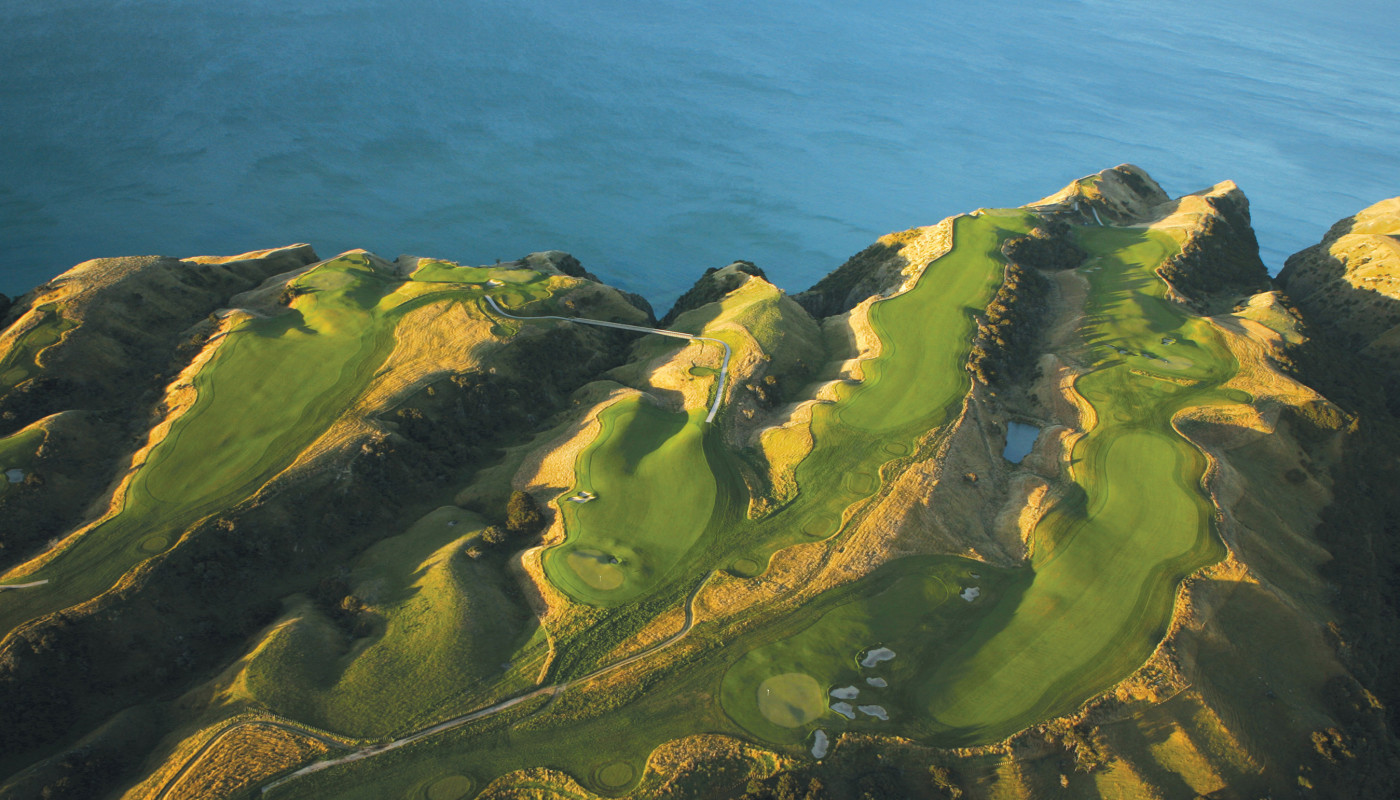 An aerial view of fairways at Cape Kidnappers Golf Course rolling out to cliffs overlooking Hawke’s Bay in New Zealand.