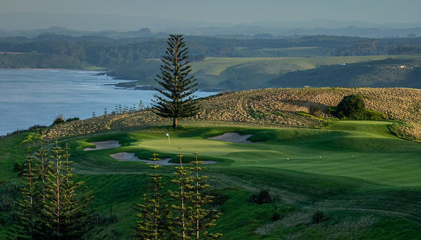 Overhead view of a fairway and green running up to a cliff edge at Kauri Cliffs Golf Course in Matauri Bay, New Zealand.