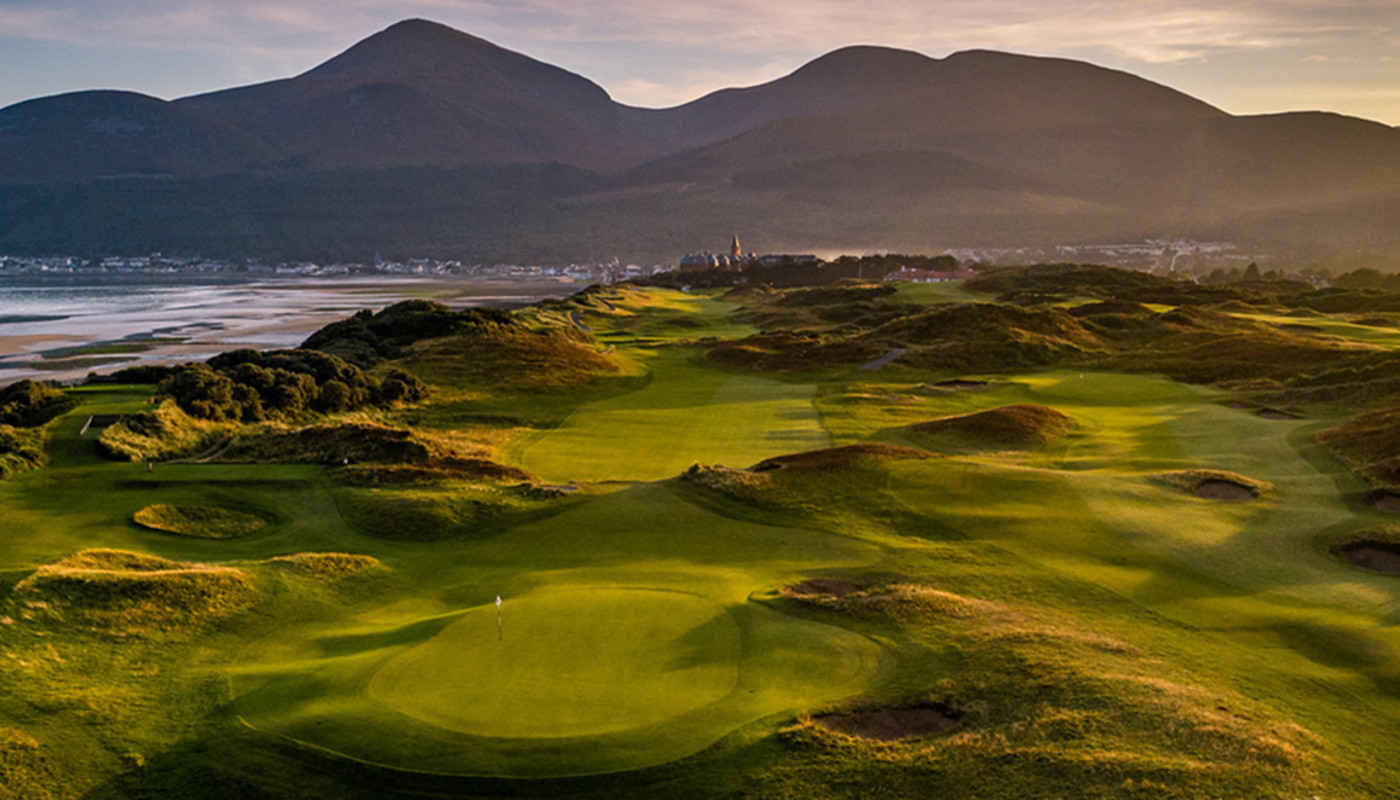 An overhead view of the 9th hole at Royal County Down Golf Club in front of the Mourne mountains in Newcastle, Northern Ireland.