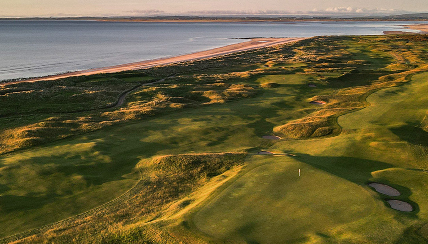 An aerial view of the 4th and 12th holes at Royal Dornoch Golf Club along the coast of the North Sea in Dornoch, Scotland.