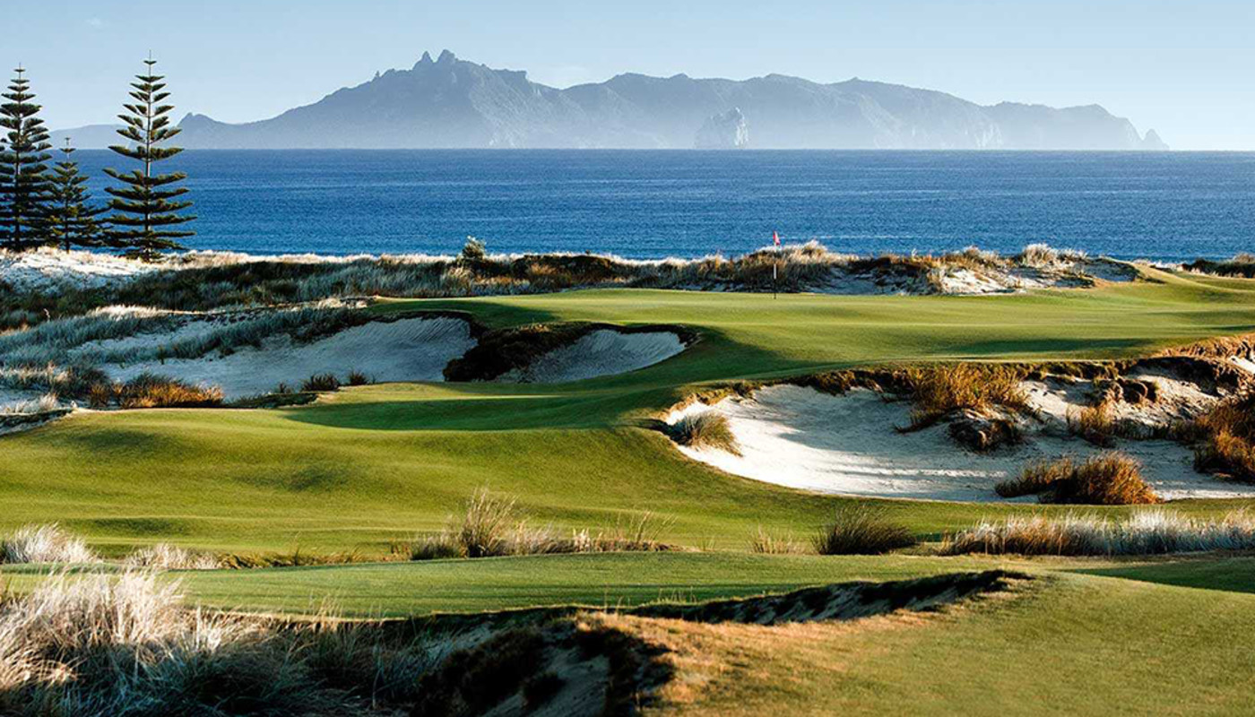 An winding hole at Te Arai Links course in Tomarata, New Zealand carving through the beach along the South Pacific coast.