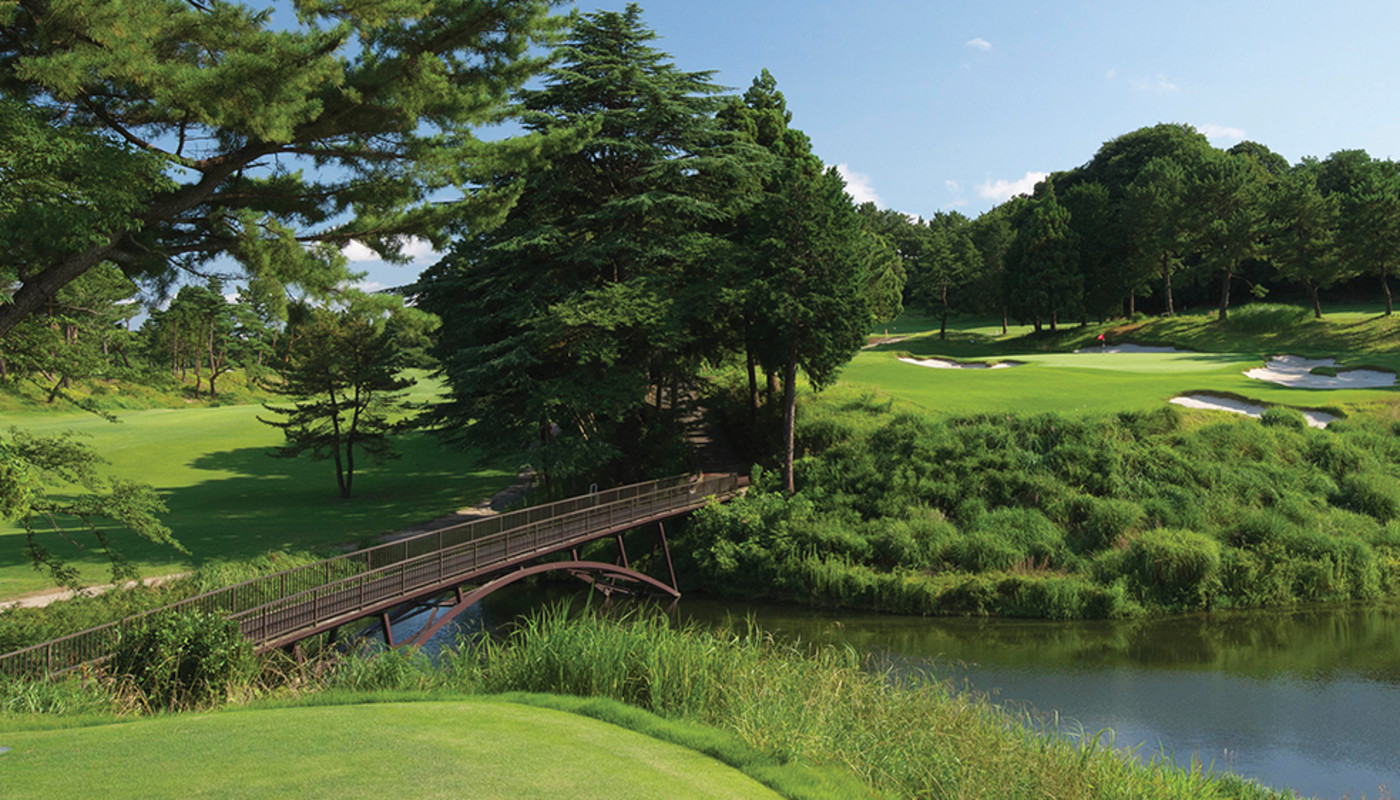 A bridge crosses over a lake, leading to the 12th green on the West Course at Yokohama Country Club outside of Tokyo, Japan.