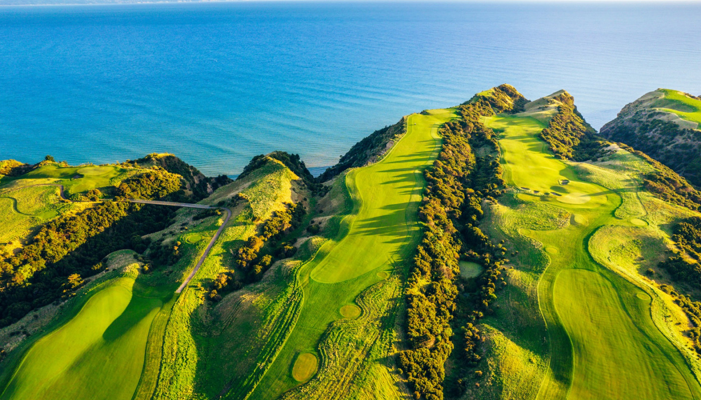 An aerial view of fairways at Cape Kidnappers Golf Course rolling out to cliffs overlooking Hawke’s Bay in New Zealand.