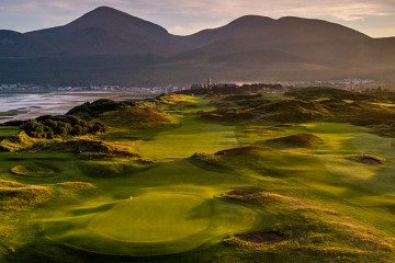 An overhead view of the 9th hole at Royal County Down Golf Club in front of the Mourne mountains in Newcastle, Northern Ireland.