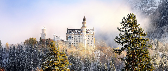 Splendid scene of royal castle Neuschwanstein and surrounding area in Bavaria, Germany (Deutschland). Famous Bavarian destination sign at sunny snowy winter day