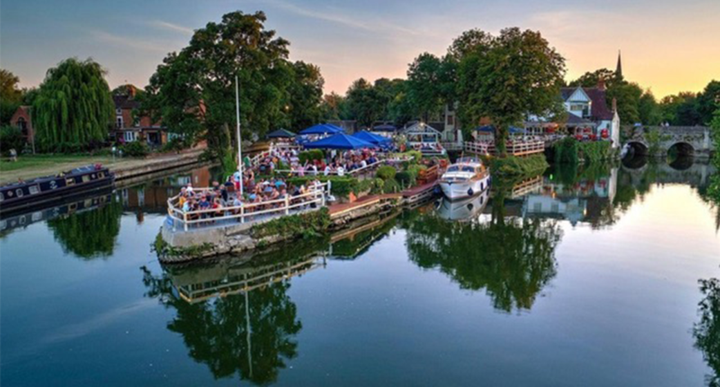 The Nag's Head pub's in Abingdon. Pub gardens and building in the background, all located on an island in the middle of the Thames.