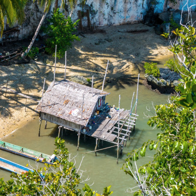 Local people, Bamboo Hut and Boats on Beach in low Tide, Kabui Bay near Waigeo, West Papuan, Raja Ampat, Indonesia, Asia