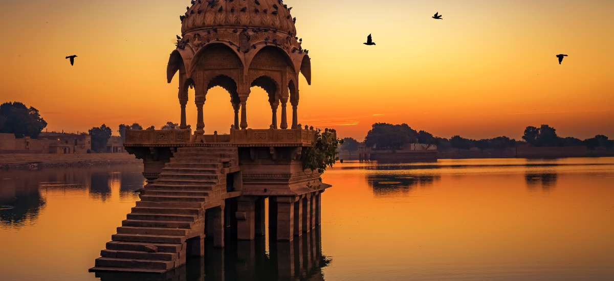 Ancient temple ruins at Gadi Sagar lake Jaipur Rajasthan at sunrise