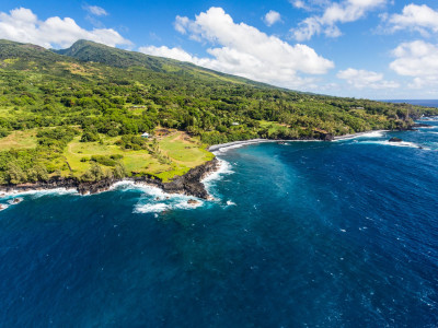a large body of water with a mountain in the background