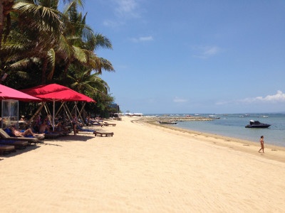 an umbrella sitting on top of a sandy beach