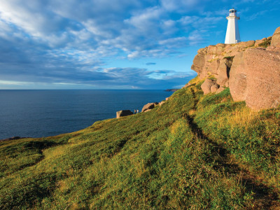 a rocky island in the middle of a grassy hill