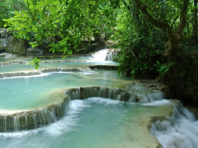 a large waterfall and a pool of water