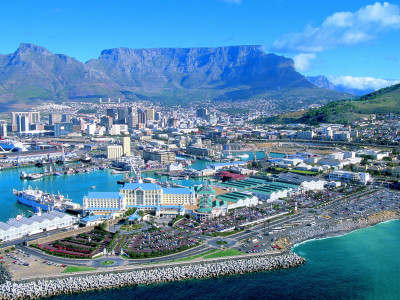 a harbor filled with blue water and a mountain in the background