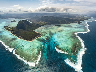 a body of water with a mountain in the background