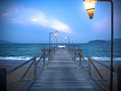 a wooden pier next to a body of water