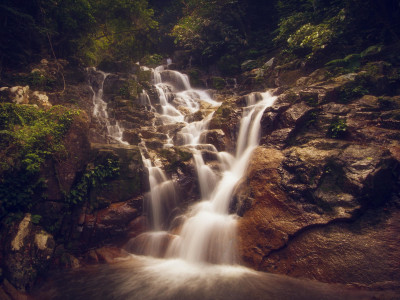 a waterfall with trees in the background